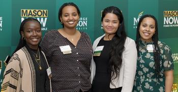 scholarship recipients pose at dinner